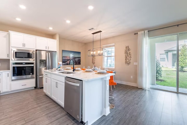 7951 Haverhill Way, Kissimmee, FL 34747 - kitchen featuring stainless steel appliances, light wood-style floors, light countertops, and recessed lighting
