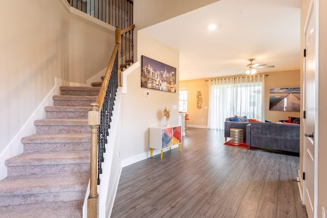 7951 Haverhill Way, Kissimmee, FL 34747 - stairway featuring a ceiling fan, wood finished floors, and baseboards