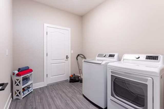 7951 Haverhill Way, Kissimmee, FL 34747 - washroom with washer and dryer, wood finished floors, and baseboards