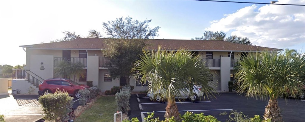 642 SE 13th Pl Unit 7, Cape Coral, FL 33990 - view of front of home featuring stucco siding and stairs