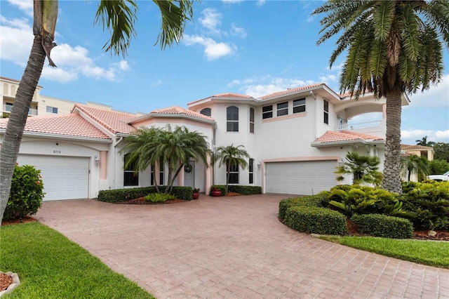 618 Manatee Bay Dr, Cape Canaveral, FL 32920 - mediterranean / spanish-style house with decorative driveway, a tile roof, and stucco siding