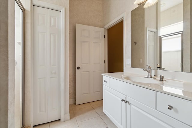 618 Manatee Bay Dr, Cape Canaveral, FL 32920 - bathroom with a closet, vanity, and tile patterned floors