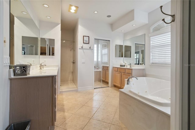 618 Manatee Bay Dr, Cape Canaveral, FL 32920 - full bathroom featuring a jetted tub, tile patterned flooring, walk in shower, two vanities, and recessed lighting