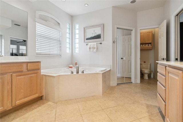 618 Manatee Bay Dr, Cape Canaveral, FL 32920 - full bathroom with vanity, a bath, tile patterned floors, and a ceiling fan