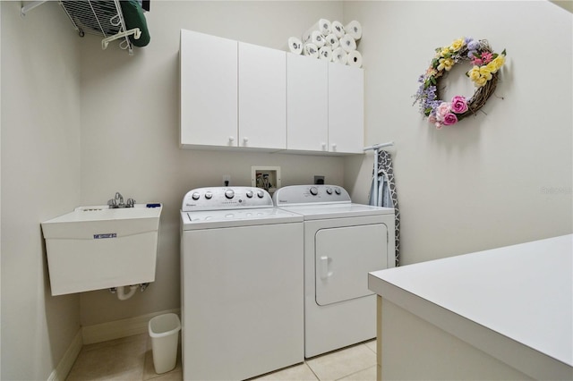 618 Manatee Bay Dr, Cape Canaveral, FL 32920 - laundry area featuring cabinet space, independent washer and dryer, and light tile patterned flooring
