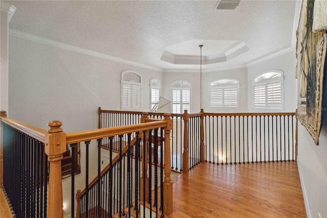 618 Manatee Bay Dr, Cape Canaveral, FL 32920 - hall with an upstairs landing, ornamental molding, healthy amount of natural light, wood finished floors, and a raised ceiling
