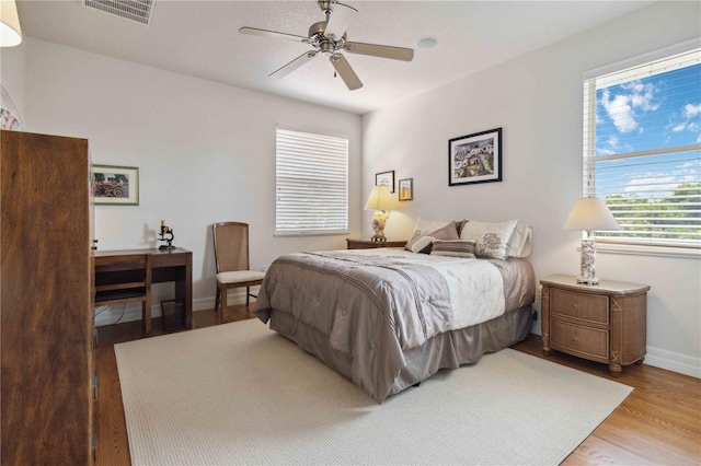 618 Manatee Bay Dr, Cape Canaveral, FL 32920 - bedroom with wood finished floors and a ceiling fan
