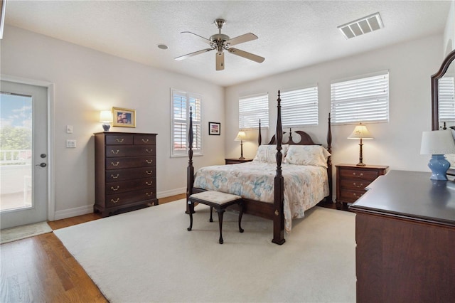618 Manatee Bay Dr, Cape Canaveral, FL 32920 - bedroom featuring light wood-style flooring, access to exterior, and ceiling fan