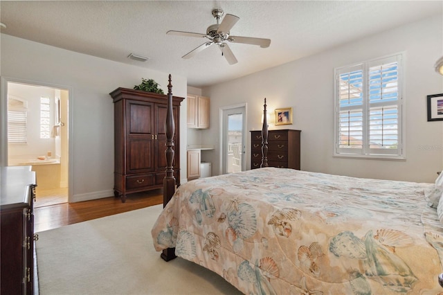 618 Manatee Bay Dr, Cape Canaveral, FL 32920 - bedroom featuring ensuite bathroom, wood finished floors, and ceiling fan