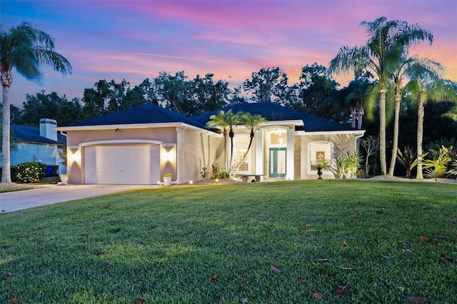 1907 Sir Lancelot Cir, Saint Cloud, FL 34772 - view of front of home featuring stucco siding, a front yard, an attached garage, and concrete driveway