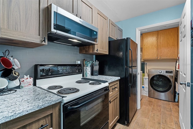 3028 Parkway Blvd Unit 308, Kissimmee, FL 34747 - kitchen featuring washer / dryer, electric range, stainless steel microwave, backsplash, and light wood-style floors