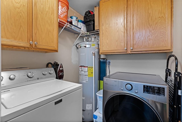 3028 Parkway Blvd Unit 308, Kissimmee, FL 34747 - laundry area featuring electric water heater, cabinet space, and independent washer and dryer