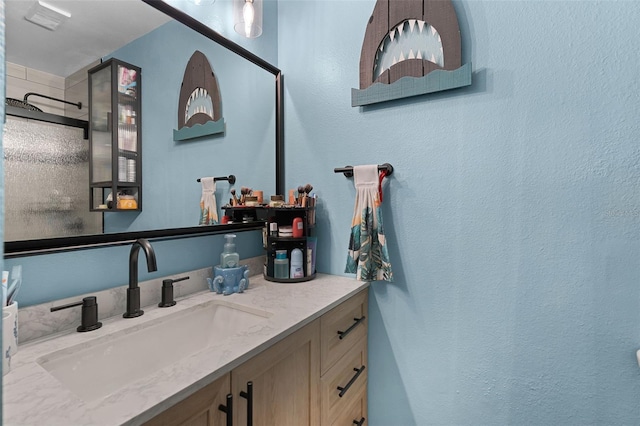 3028 Parkway Blvd Unit 308, Kissimmee, FL 34747 - full bath featuring vanity, a shower, and a textured wall