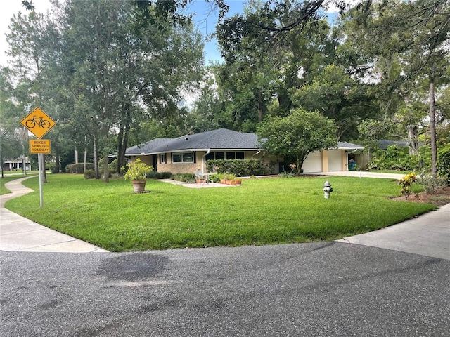 955 Gamewell Ave, Maitland, FL 32751 - ranch-style home with driveway, a front lawn, and an attached garage