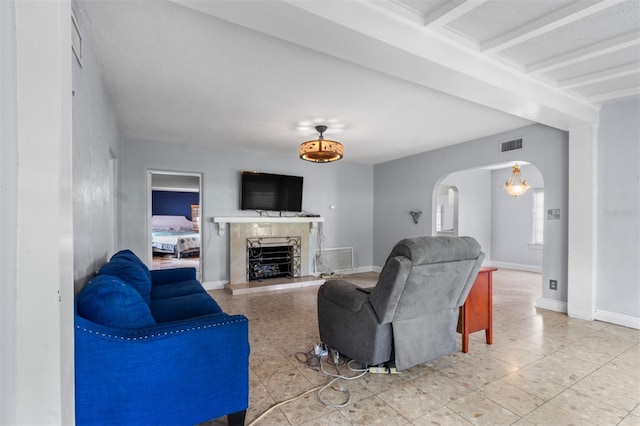 4420 Conway Gardens Rd, Orlando, FL 32806 - living area featuring arched walkways, a fireplace with raised hearth, and baseboards