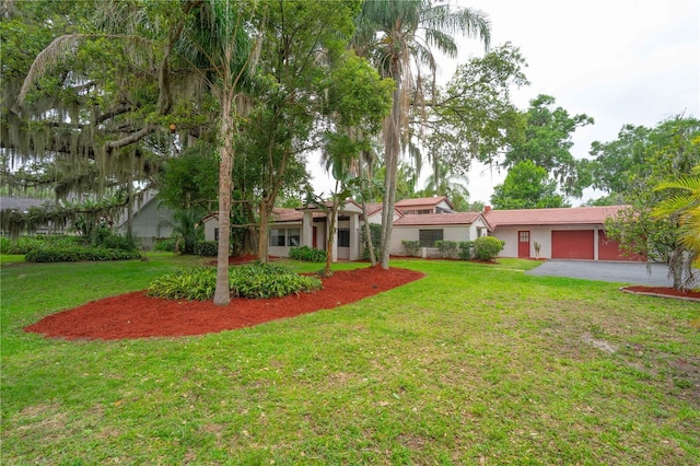 4420 Conway Gardens Rd, Orlando, FL 32806 - view of green lawn with an attached garage and driveway