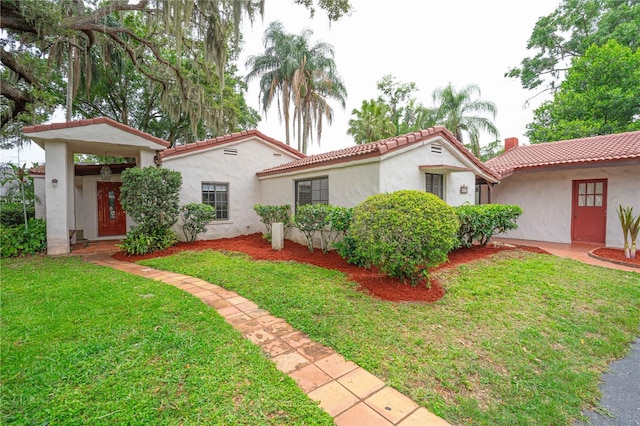 4420 Conway Gardens Rd, Orlando, FL 32806 - mediterranean / spanish home with stucco siding, a tile roof, and a front lawn