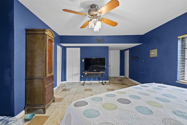 4420 Conway Gardens Rd, Orlando, FL 32806 - bedroom featuring baseboards, stone tile flooring, and a ceiling fan