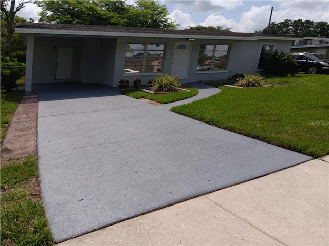 2103 Mantilla Ave, Orlando, FL 32811 - ranch-style home with concrete driveway, a front lawn, stucco siding, and a carport