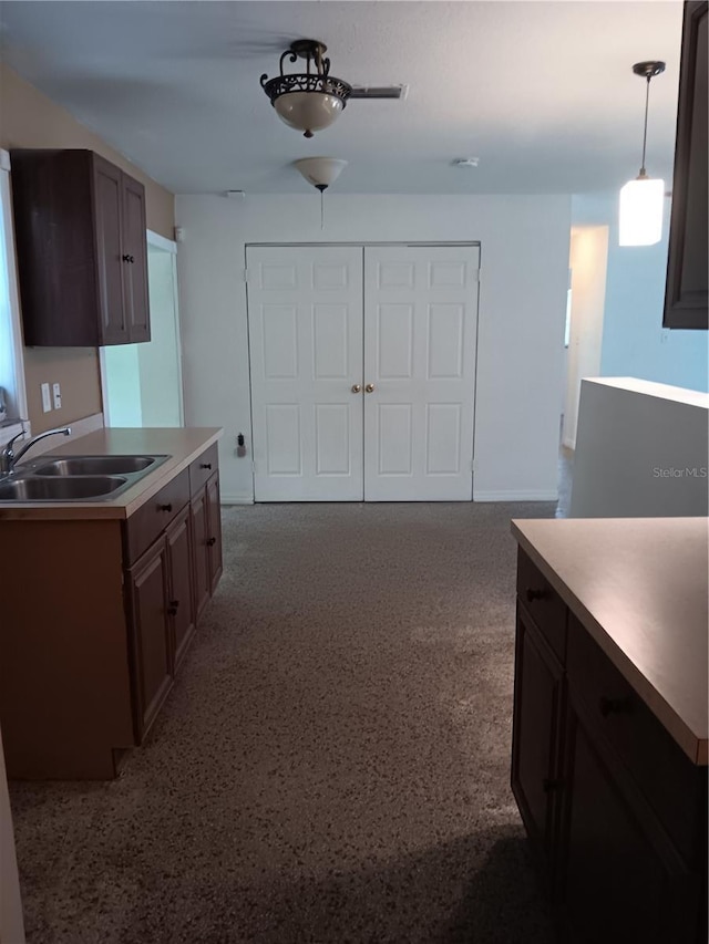 2103 Mantilla Ave, Orlando, FL 32811 - kitchen with light countertops and pendant lighting