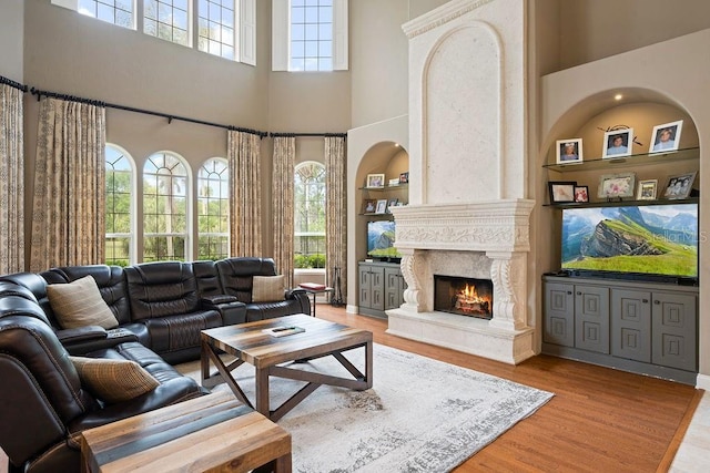 2357 Alaqua Dr, Longwood, FL 32779 - living area featuring a high ceiling, light wood-style flooring, and a fireplace
