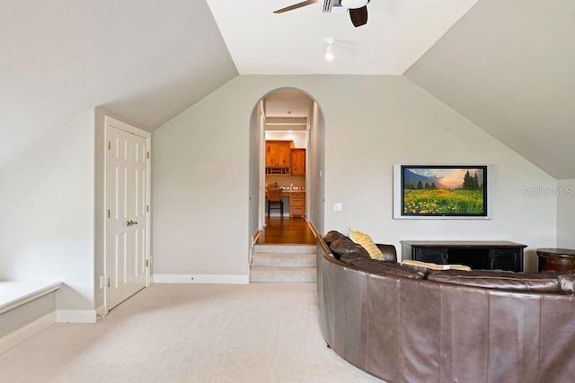 2357 Alaqua Dr, Longwood, FL 32779 - living area with a ceiling fan, lofted ceiling, light colored carpet, baseboards, and arched walkways