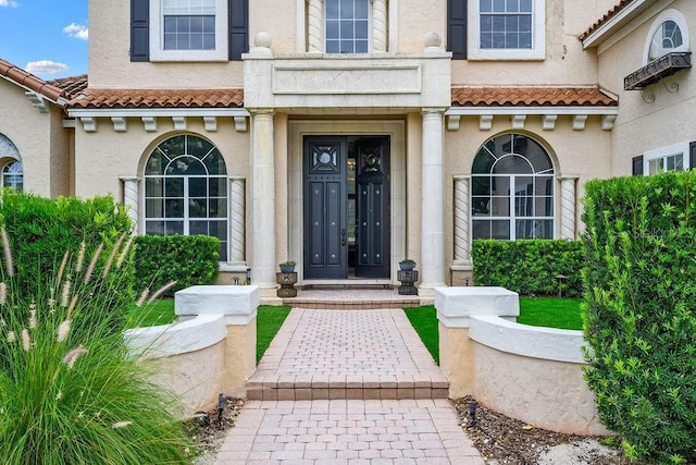 2357 Alaqua Dr, Longwood, FL 32779 - doorway to property featuring stucco siding, a tiled roof, and a balcony