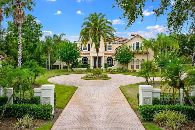 2357 Alaqua Dr, Longwood, FL 32779 - mediterranean / spanish home with curved driveway, stucco siding, and a front lawn