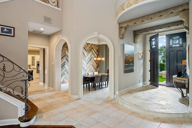 2357 Alaqua Dr, Longwood, FL 32779 - entryway with a chandelier, baseboards, a towering ceiling, and light tile patterned flooring