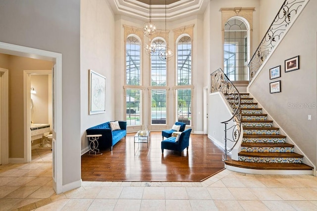 2357 Alaqua Dr, Longwood, FL 32779 - tiled foyer entrance with a towering ceiling, a chandelier, stairway, and baseboards
