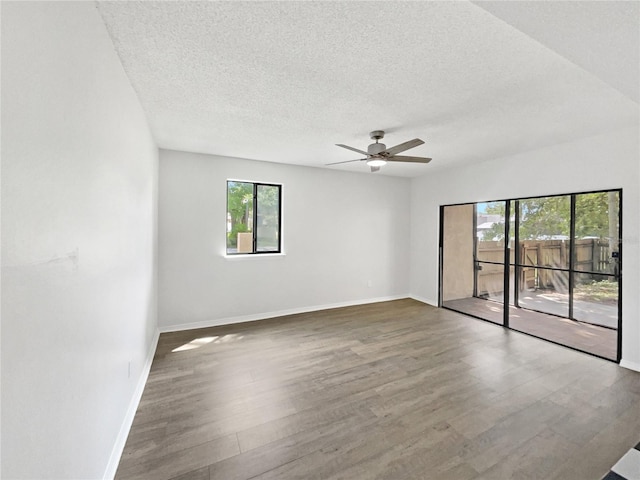 1404 Oak Pl Unit A, Apopka, FL 32712 - empty room with plenty of natural light, wood finished floors, a textured ceiling, and baseboards