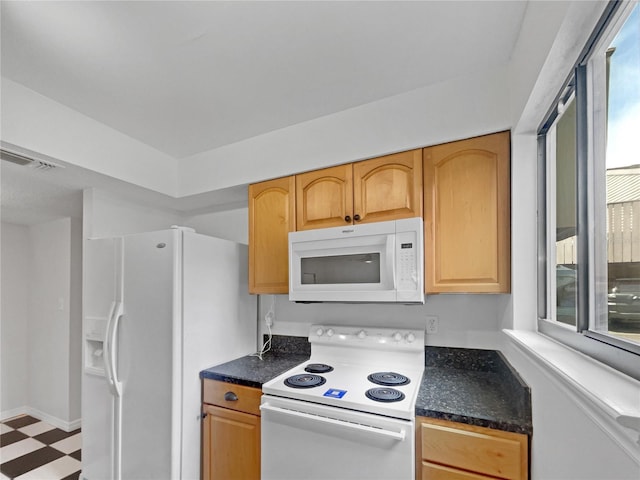 1404 Oak Pl Unit A, Apopka, FL 32712 - kitchen with white appliances, tile patterned floors, plenty of natural light, and dark countertops