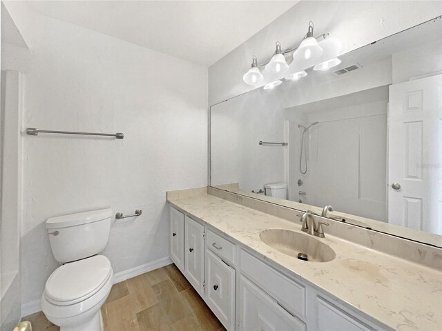 1404 Oak Pl Unit A, Apopka, FL 32712 - bathroom featuring toilet, vanity, baseboards, and wood finished floors