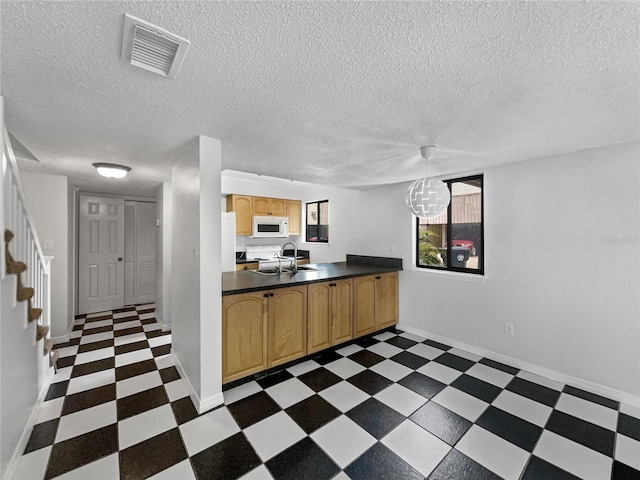 1404 Oak Pl Unit A, Apopka, FL 32712 - kitchen with dark floors, white appliances, dark countertops, a textured ceiling, and baseboards