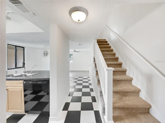 1404 Oak Pl Unit A, Apopka, FL 32712 - stairs featuring tile patterned floors, a textured ceiling, healthy amount of natural light, ceiling fan, and bar with sink