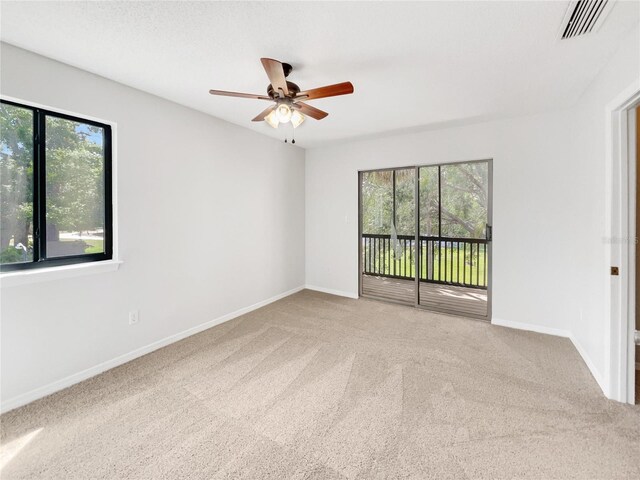 1404 Oak Pl Unit A, Apopka, FL 32712 - unfurnished room featuring plenty of natural light, carpet floors, a ceiling fan, and baseboards