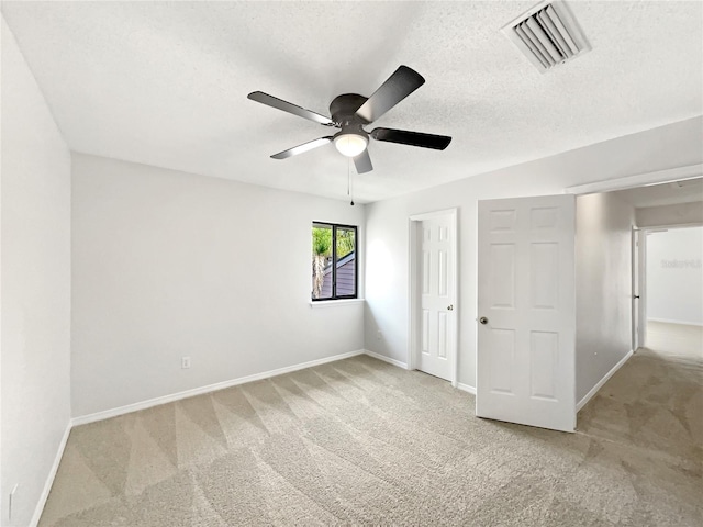 1404 Oak Pl Unit A, Apopka, FL 32712 - unfurnished bedroom featuring carpet floors, baseboards, a textured ceiling, and a ceiling fan