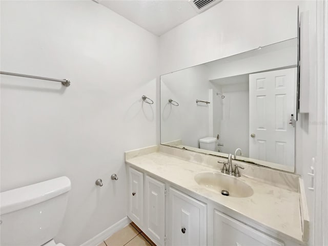 1404 Oak Pl Unit A, Apopka, FL 32712 - bathroom with toilet, vanity, tile patterned floors, and baseboards
