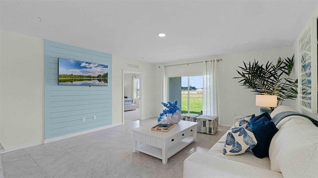 living area with recessed lighting, baseboards, and light tile patterned floors