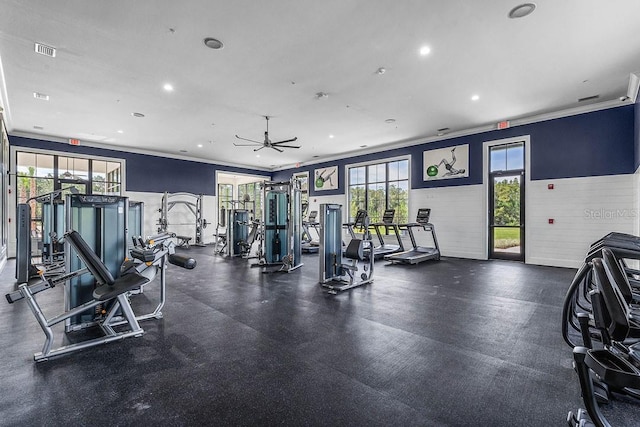 exercise room featuring ornamental molding, recessed lighting, wainscoting, and ceiling fan