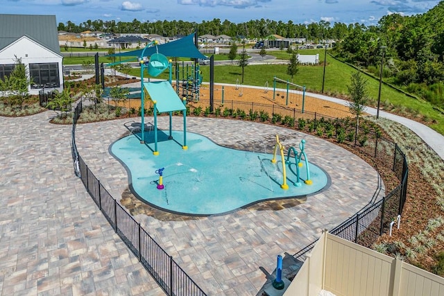 view of swimming pool with a water play area