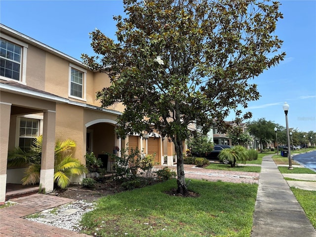 11187 Savannah Landing Cir, Orlando, FL 32832 - view of home's exterior with stucco siding and a yard