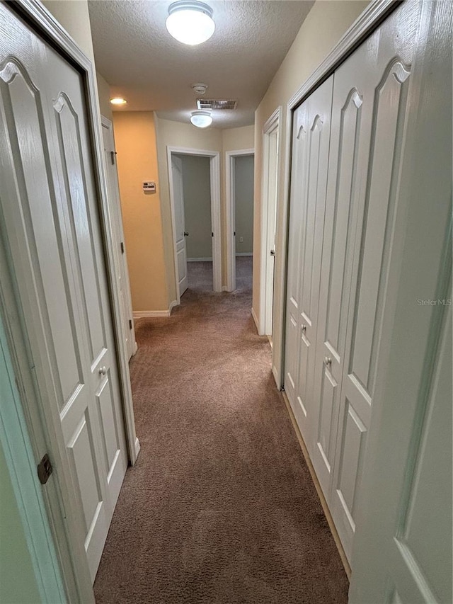 11187 Savannah Landing Cir, Orlando, FL 32832 - hall with a textured ceiling, carpet flooring, and baseboards
