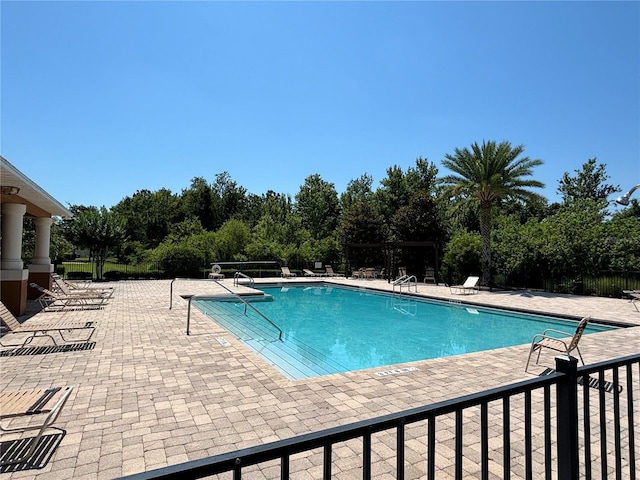 11187 Savannah Landing Cir, Orlando, FL 32832 - community pool with a patio area and view of wooded area