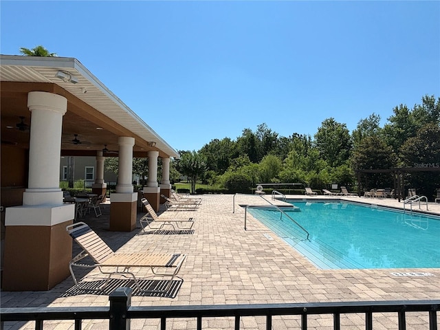 11187 Savannah Landing Cir, Orlando, FL 32832 - community pool with a patio area and ceiling fan