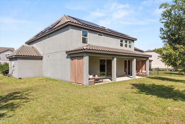 2340 Standing Rock Cir, Oakland, FL 34787 - rear view of property featuring a patio area, roof mounted solar panels, stucco siding, and a tile roof