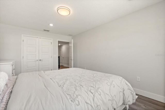 2340 Standing Rock Cir, Oakland, FL 34787 - bedroom with baseboards, dark wood-style flooring, a closet, and recessed lighting