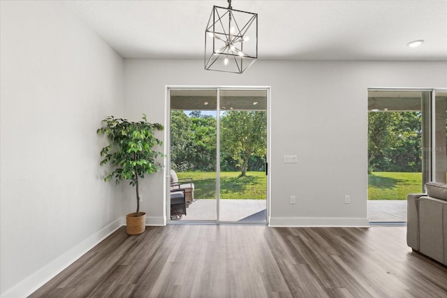 2340 Standing Rock Cir, Oakland, FL 34787 - unfurnished dining area featuring wood finished floors, a chandelier, and baseboards
