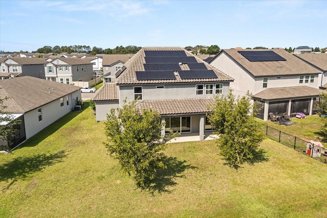 2340 Standing Rock Cir, Oakland, FL 34787 - rear view of house featuring a residential view, a tiled roof, solar panels, a patio, and stucco siding