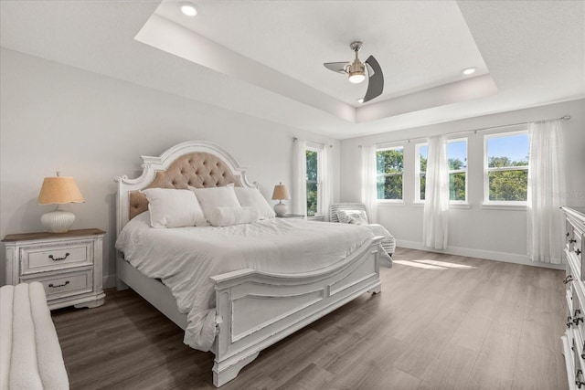 2340 Standing Rock Cir, Oakland, FL 34787 - bedroom with a tray ceiling, wood finished floors, recessed lighting, baseboards, and ceiling fan